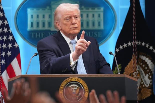 President Donald Trump speaks with reporters during a news conference.