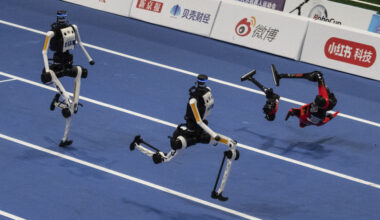 An Honor humanoid robot breaks into pieces as it runs next to two Tian Gong Ultras, center and left, in the second heat of the large robot category of the 100 meter at the 2nd World Robot Games at National Speed Skating Oval on August 25, 2026 in Beijing, China.