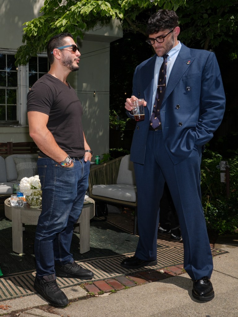 Abdul El-Sayed talks with Hasan Piker poolside at a content creators' party.