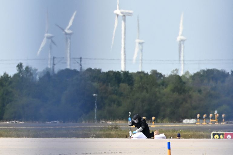 A forensic technician works at the German airport Leipzig-Halle in Schkeuditz, eastern Germany, after an explosives-laden drone was found near a Ukrainian cargo plane [AFP]