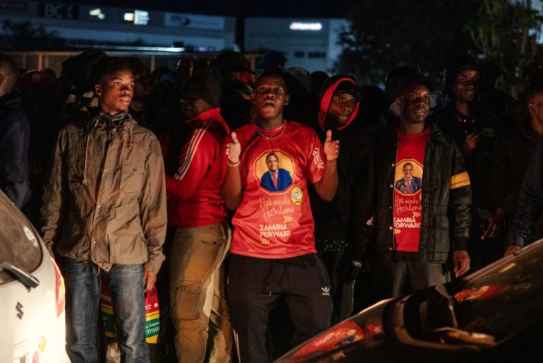 TOPSHOT - Supporters of Zambian President elect Hakainde Hichilema celebrate his victory in the street after the announcement of the Electoral Commission of Zambia in Lusaka, on August 18, 2026.