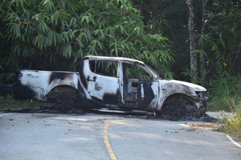 A charred vehicle is seen on a road in Ra-ngae district in the southern Thai province of Narathiwat on August 23, 2026, following dozens of coordinated arson and incendiary attacks across Thailand's insurgency-hit south.