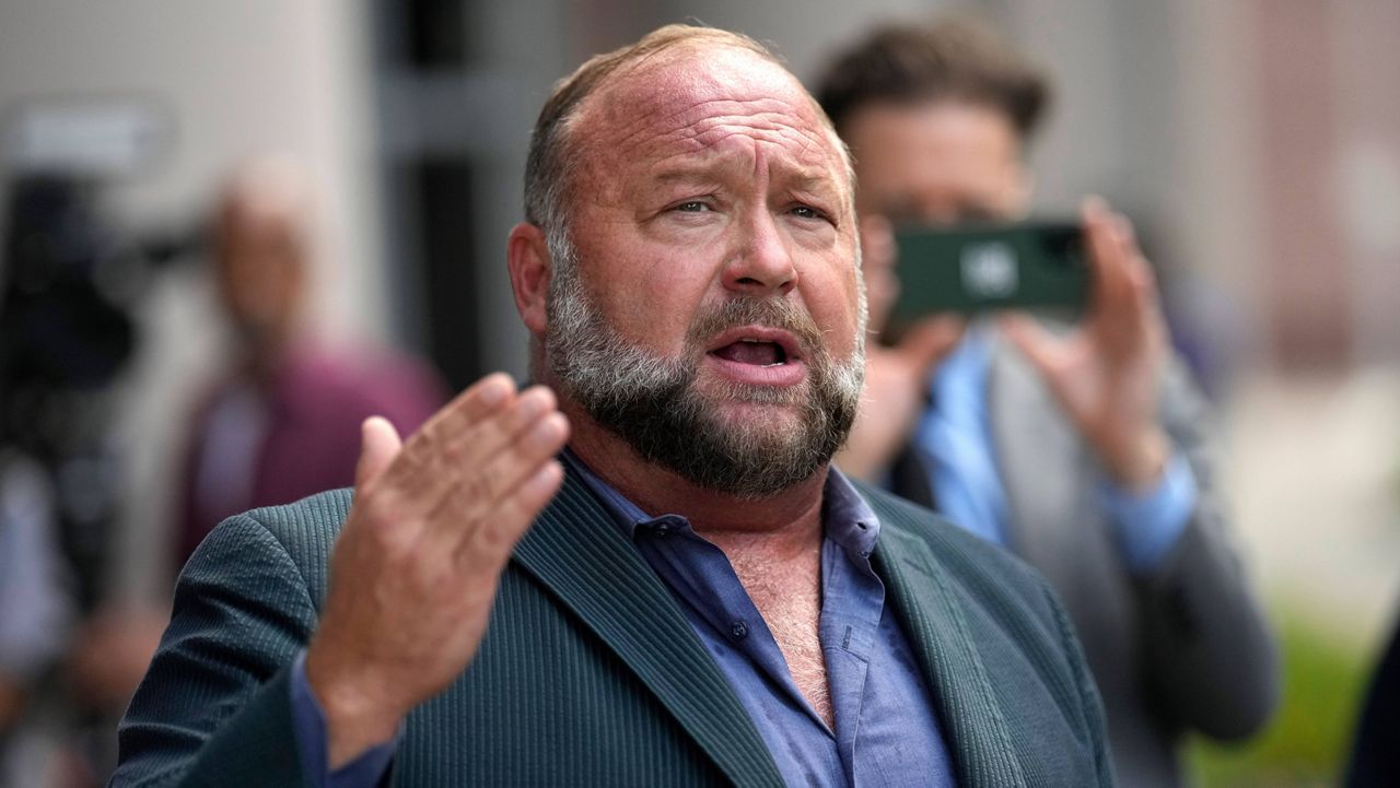 Right-wing conspiracy theorist Alex Jones speaks to the media after arriving at the federal courthouse for a hearing in front of a bankruptcy judge, June 14, 2024, in Houston. (AP Photo/David J. Phillip)