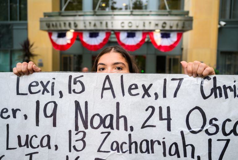 IMAGE DISTRIBUTED FOR HEAT INITIATIVE - Olivia Konar grieves while holding up a banner memorializing the loss of children who died due to social media harm during a press conference and memorial outside the Ronald V Dellums Courthouse on Tuesday, August 18, 2026 in Oakland, Calif. (Josh Edelson/AP Content Services for Heat Initiative)
