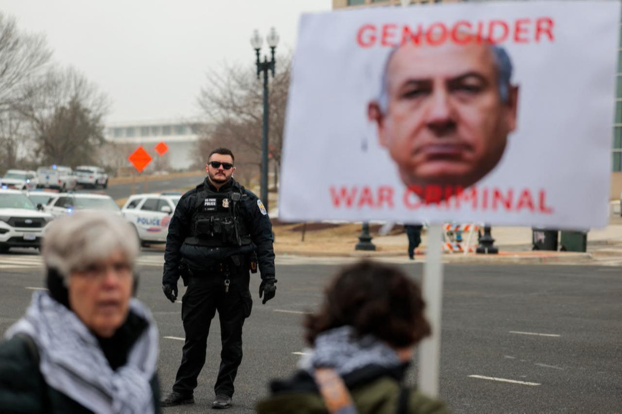 Anti-Trump and pro-Palestine protesters gather outside the Donald J. Trump Institute of Peace in Washington, DC on Feb. 19, 2026. (AFP Photo)