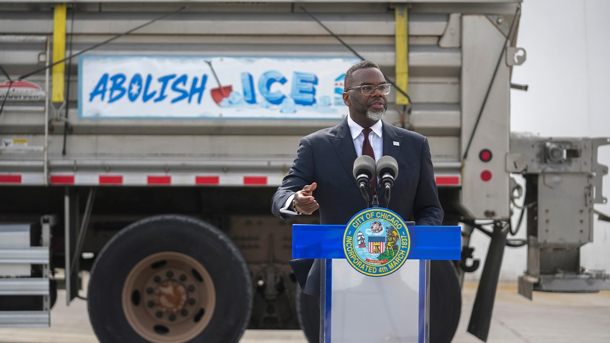 Brandon Johnson in front of snow plow truck that says 