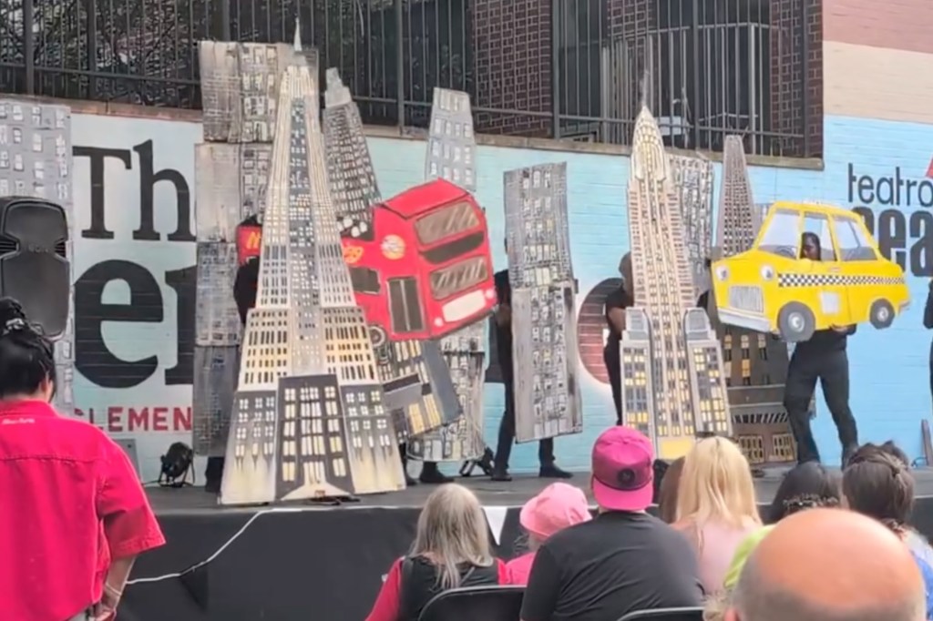 The Cardboard Pizza Puppet Circus performs a puppet show with cardboard cutouts of New York City buildings, a red double-decker bus, and a yellow taxi.