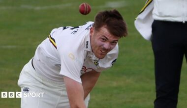 Kasey Aldridge in a white Durham shirt bowls a red ball