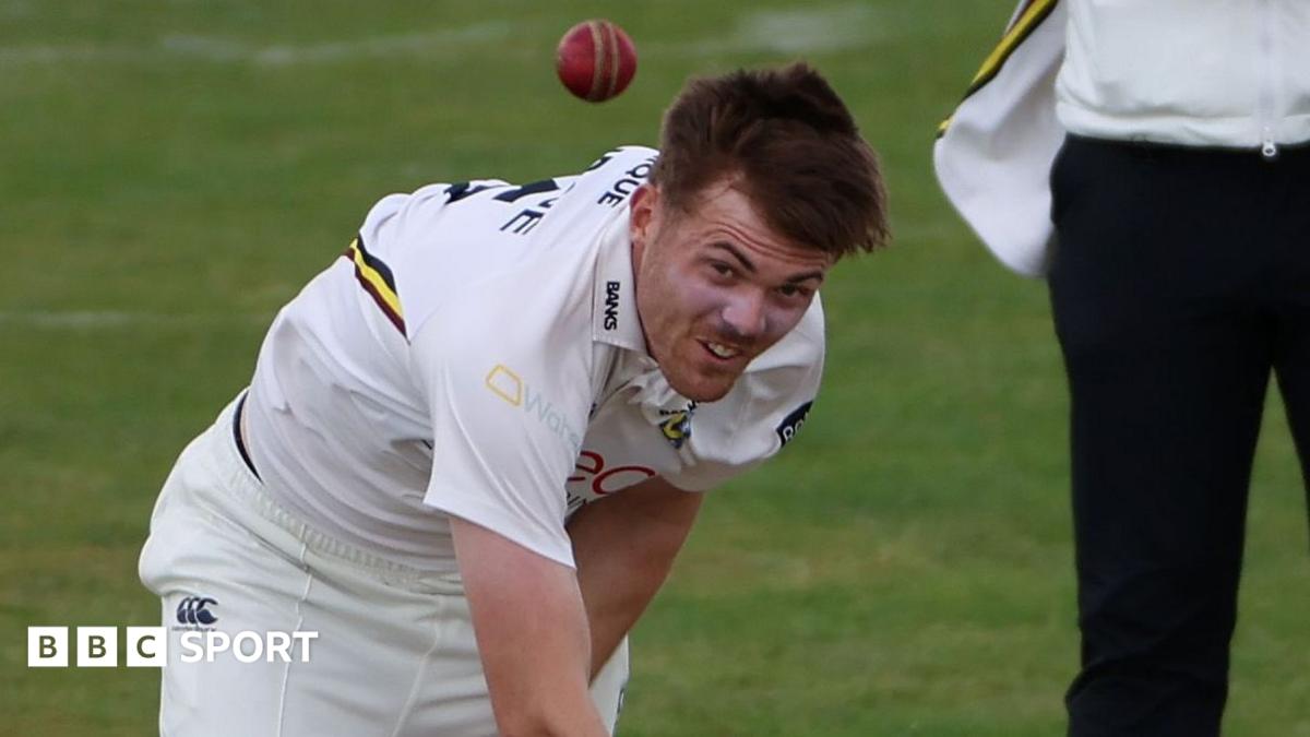 Kasey Aldridge in a white Durham shirt bowls a red ball