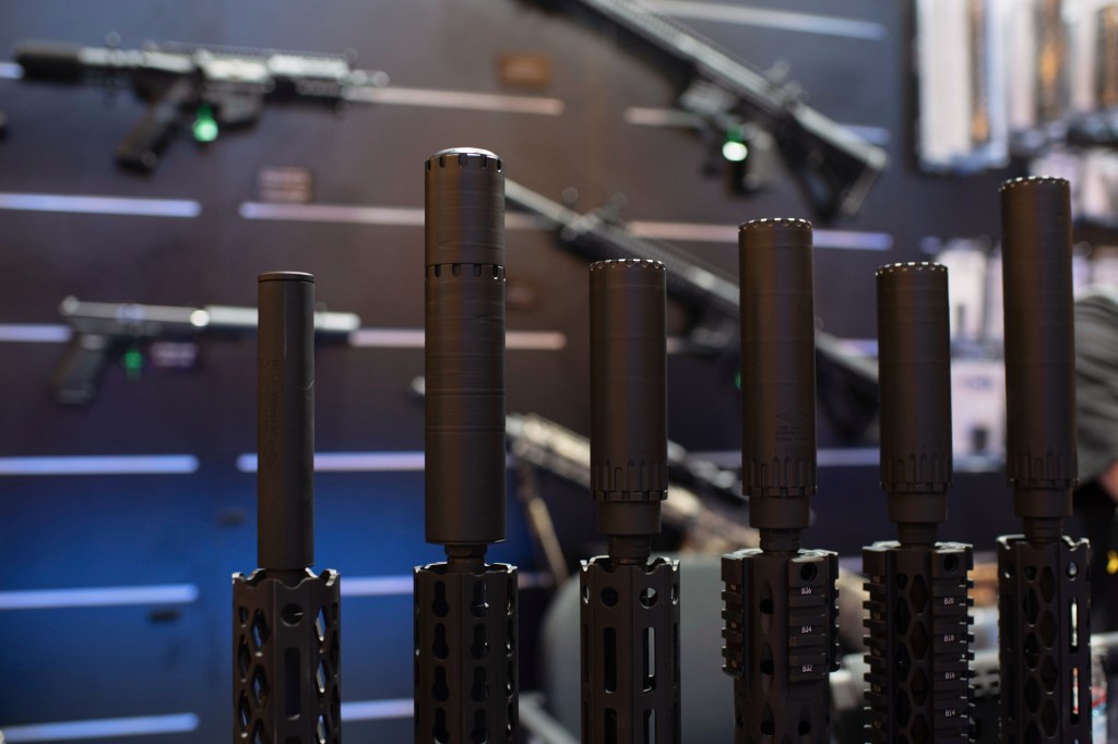 Firearms and suppressors are displayed at a gun trade in Las Vegas on Jan. 20, 2020.