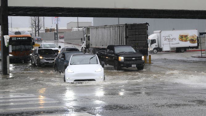 CALIFORNIA, USA - FEBRUARY 16: Cars pass on flooding water at Sawtelle neighborhood during heavy rain in Los Angeles, California, United States on February 16, 2026.