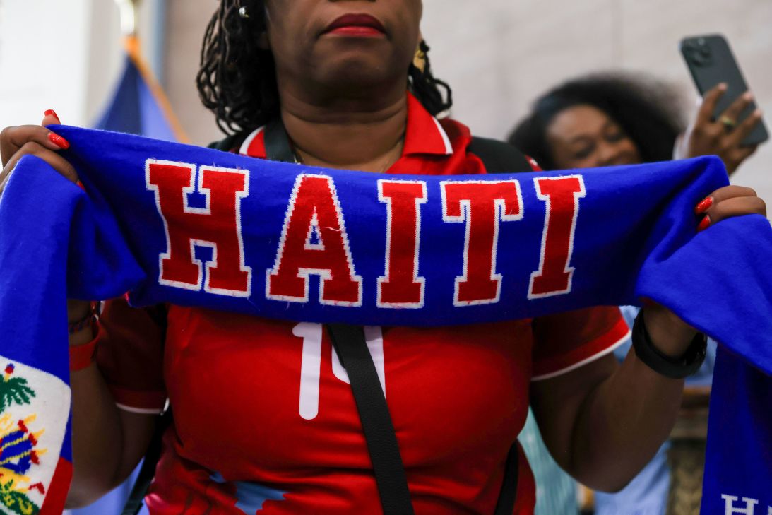 An attendee holds a sign during a rally at Brooklyn Borough Hall in New York, on July 9. Protesters called for Congress to pass a measure that would extend TPS for Haitians.