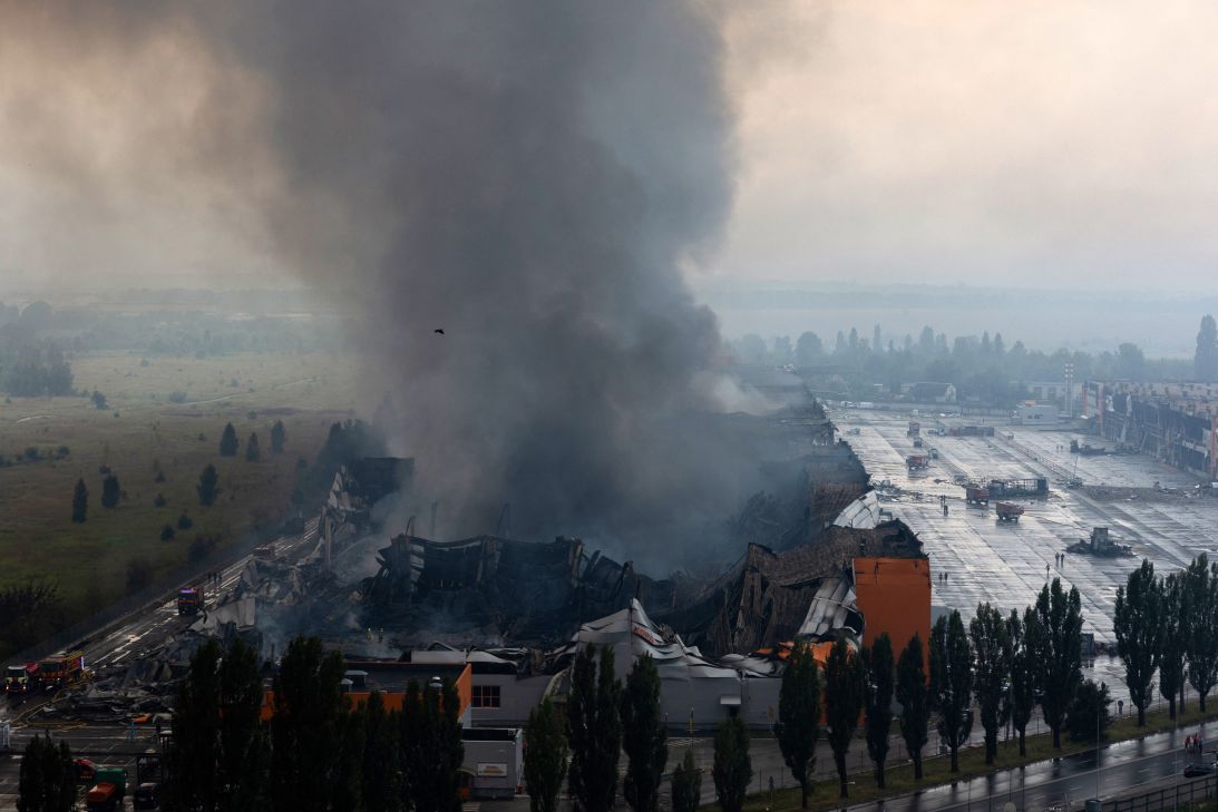 Smoke rises from a fire caused by massive Russian ballistic missile and drone strikes in Kyiv on August 5. Russian strikes on Ukraine's capital and surrounding region killed at least two people and wounded dozens more, authorities said after fresh overnight attacks.