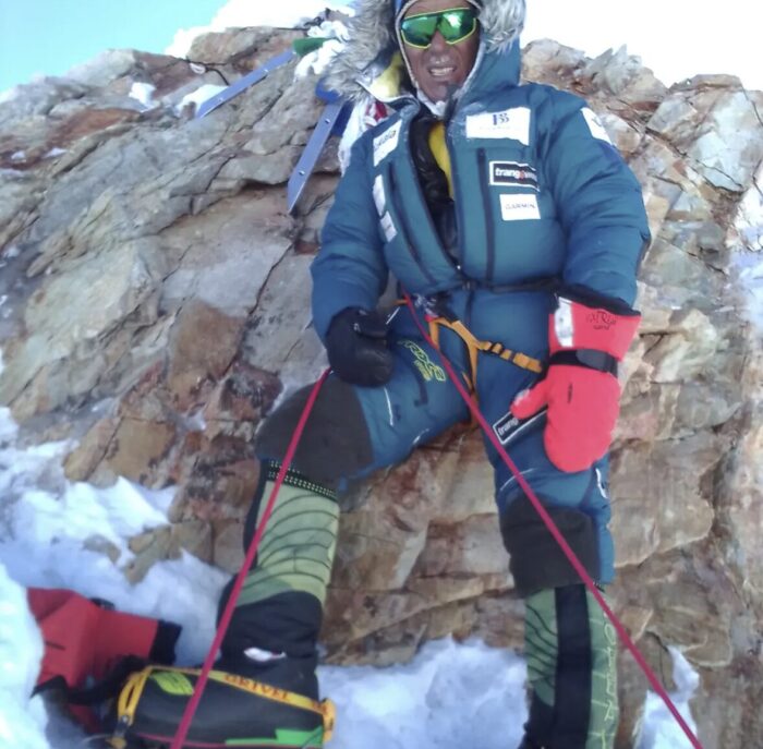 A sherpa climber on a rocky summit. 