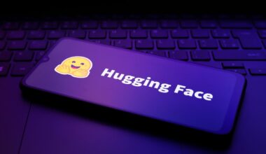The Hugging Face logo appears on the screen of a smartphone.