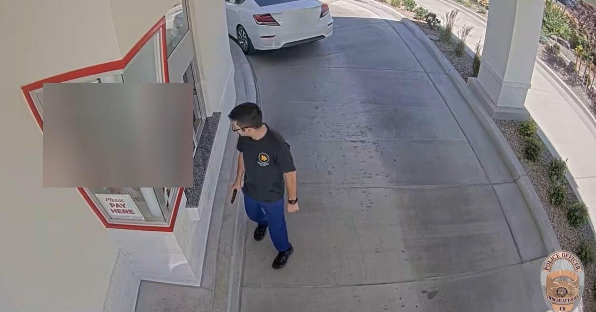 The gunman in a deadly mass shooting in Twin Falls, Idaho, looks into an In-N-Out restaurant during the rampage, Aug. 1, 2026.