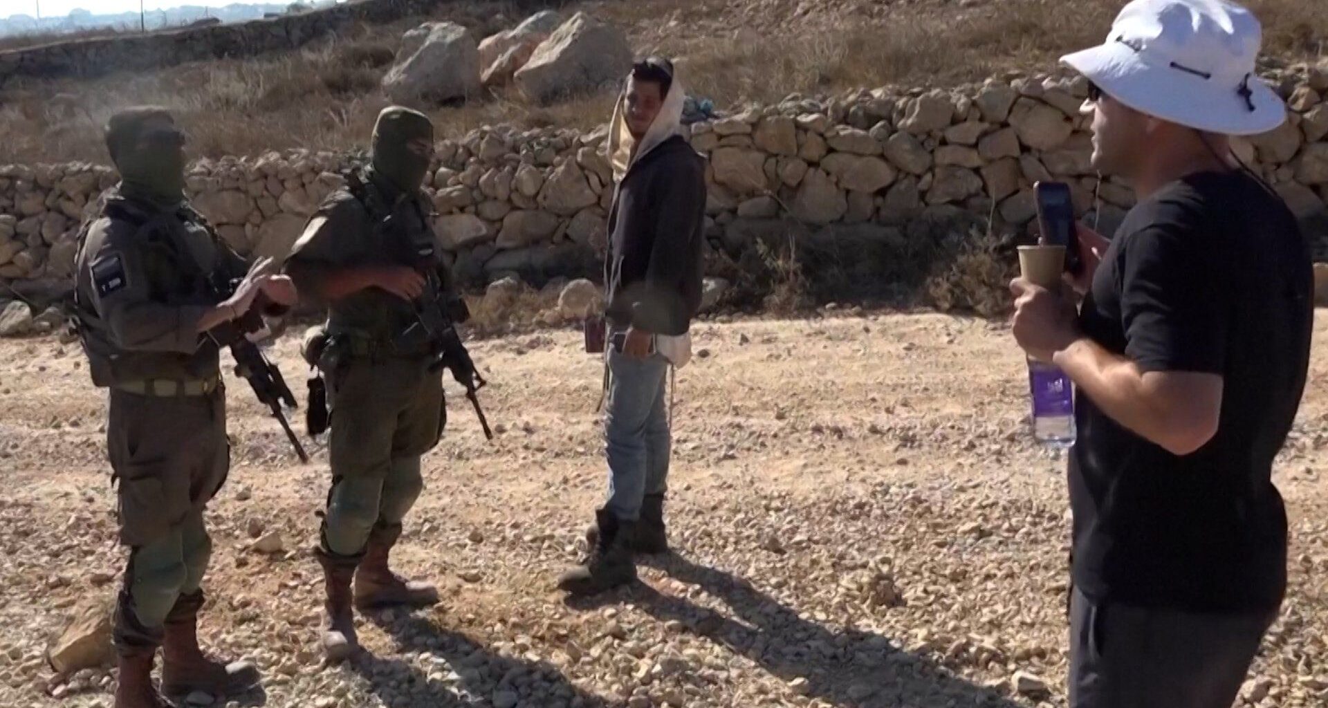 Palestinian-American confronts Israeli settler at his besieged home | Israel-Palestine conflict News