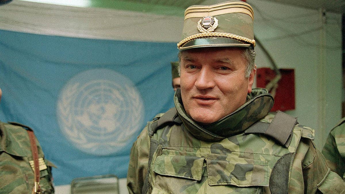 Gen. Ratko Mladic stands near a United Nations flag at Sarajevo Airport.