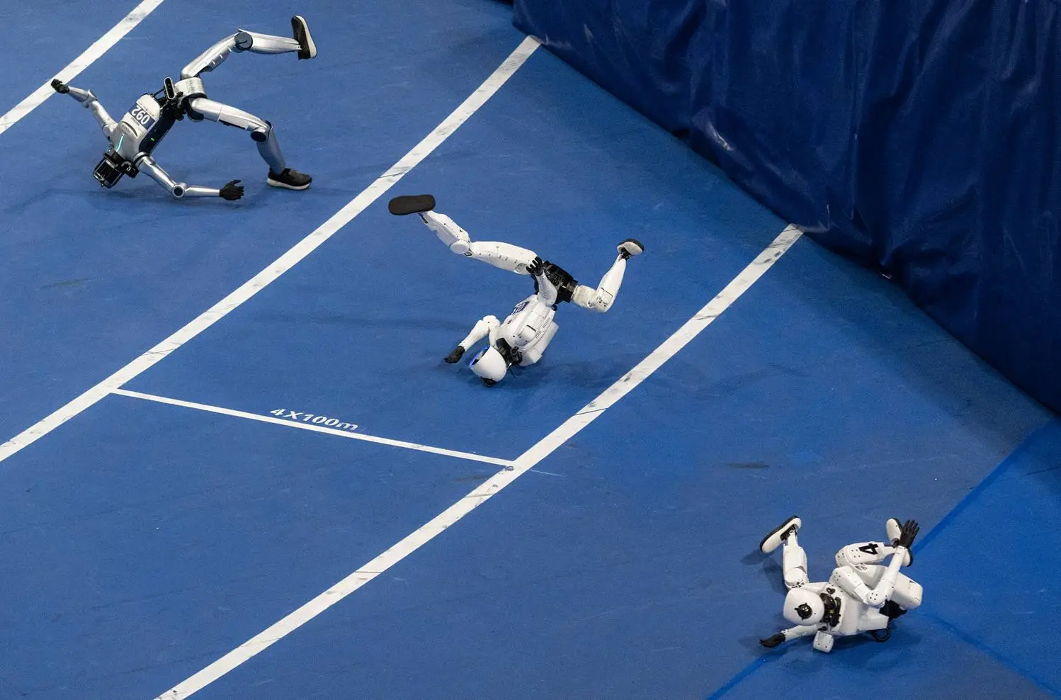 Robots are seen falling down.