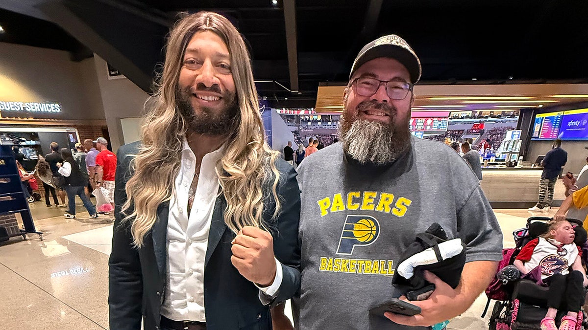Royce White poses with a fan