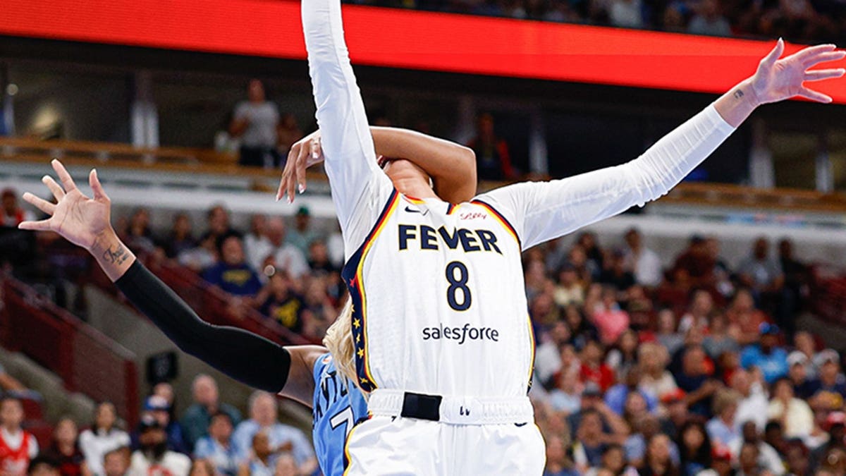 Sophie Cunningham drives to the basket as DiJonai Carrington fouls her during an Indiana Fever vs. Chicago Sky game.