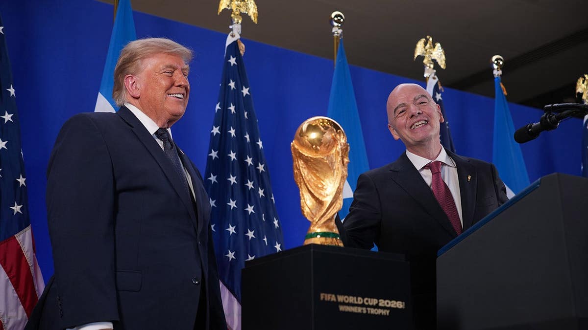 Donald Trump speaks alongside Gianni Infantino at a reception.