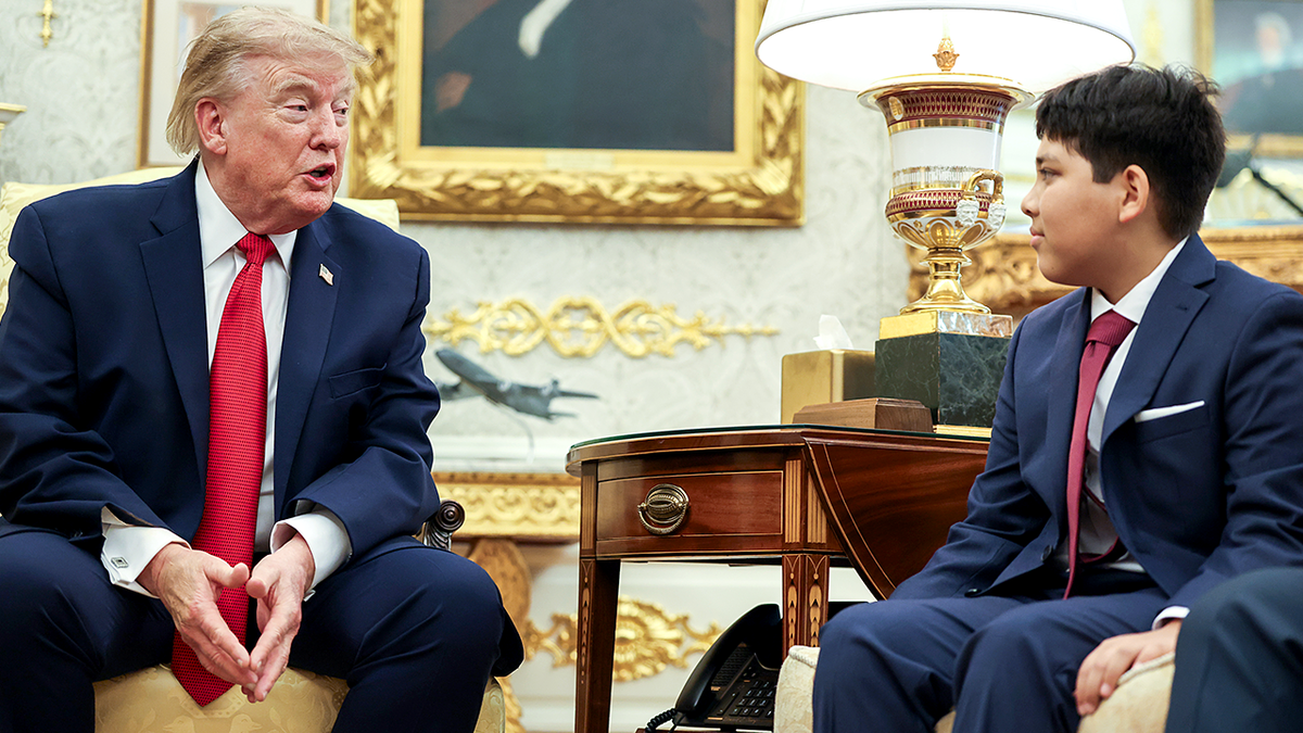 President Donald Trump speaks with Nathaniel Rai in the Oval Office.