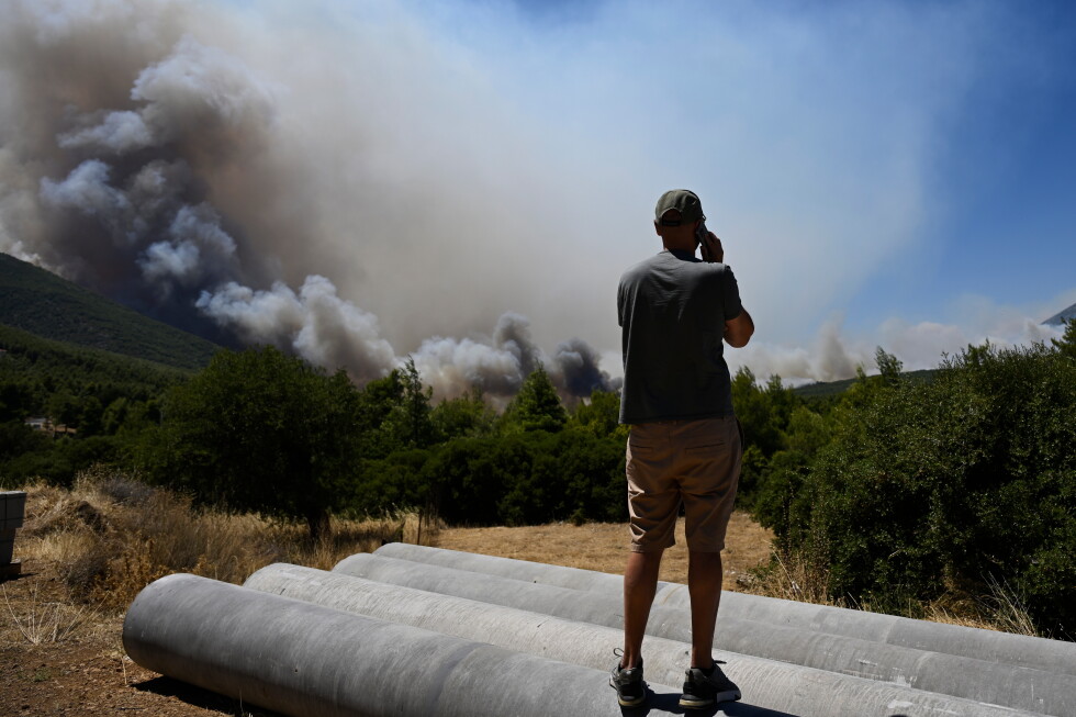 Photos show destruction from wildfires in Greece as blazes take hold in Europe and parts of the US