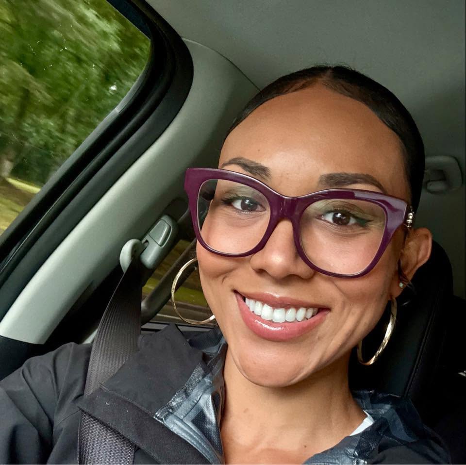McKenna West, a surrogate mother, smiling for a selfie in a car.