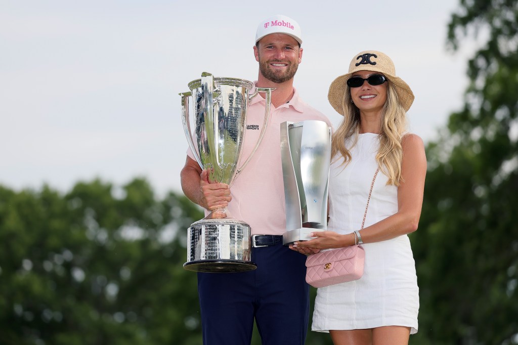 Wyndham Clark and girlfriend Emily Tanner pose with the winner's trophy after Clark's BMW Championship victory on Sunday, August 23, 2026.