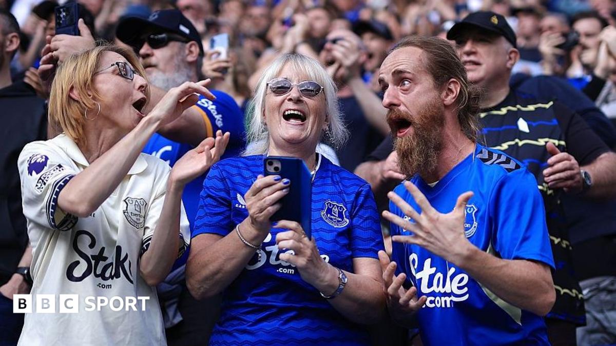 Three Everton fans enjoying a match