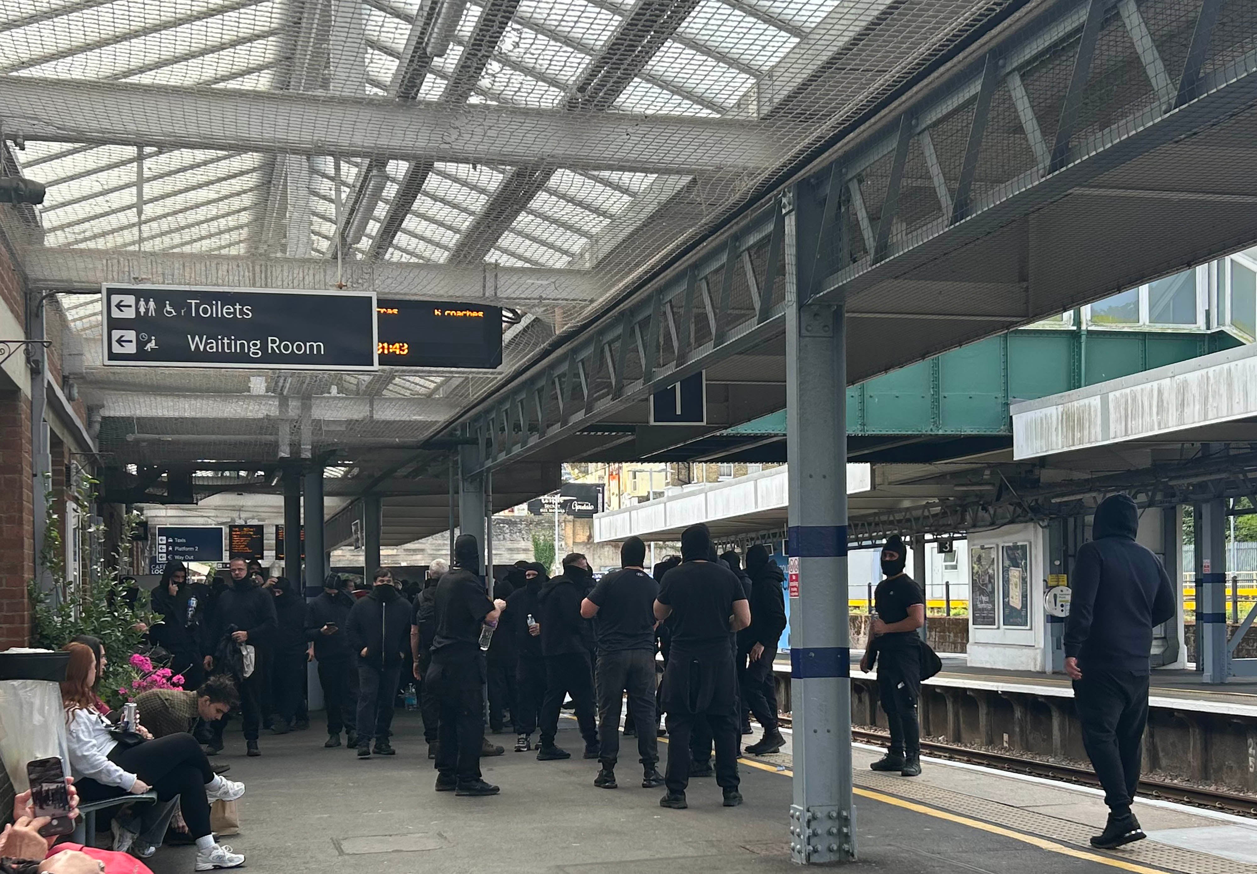 Protesters at Dover Priory train station after black-clad and masked anti-illegal migrant demonstrators blocked roads in Dover during a protest on 5 September