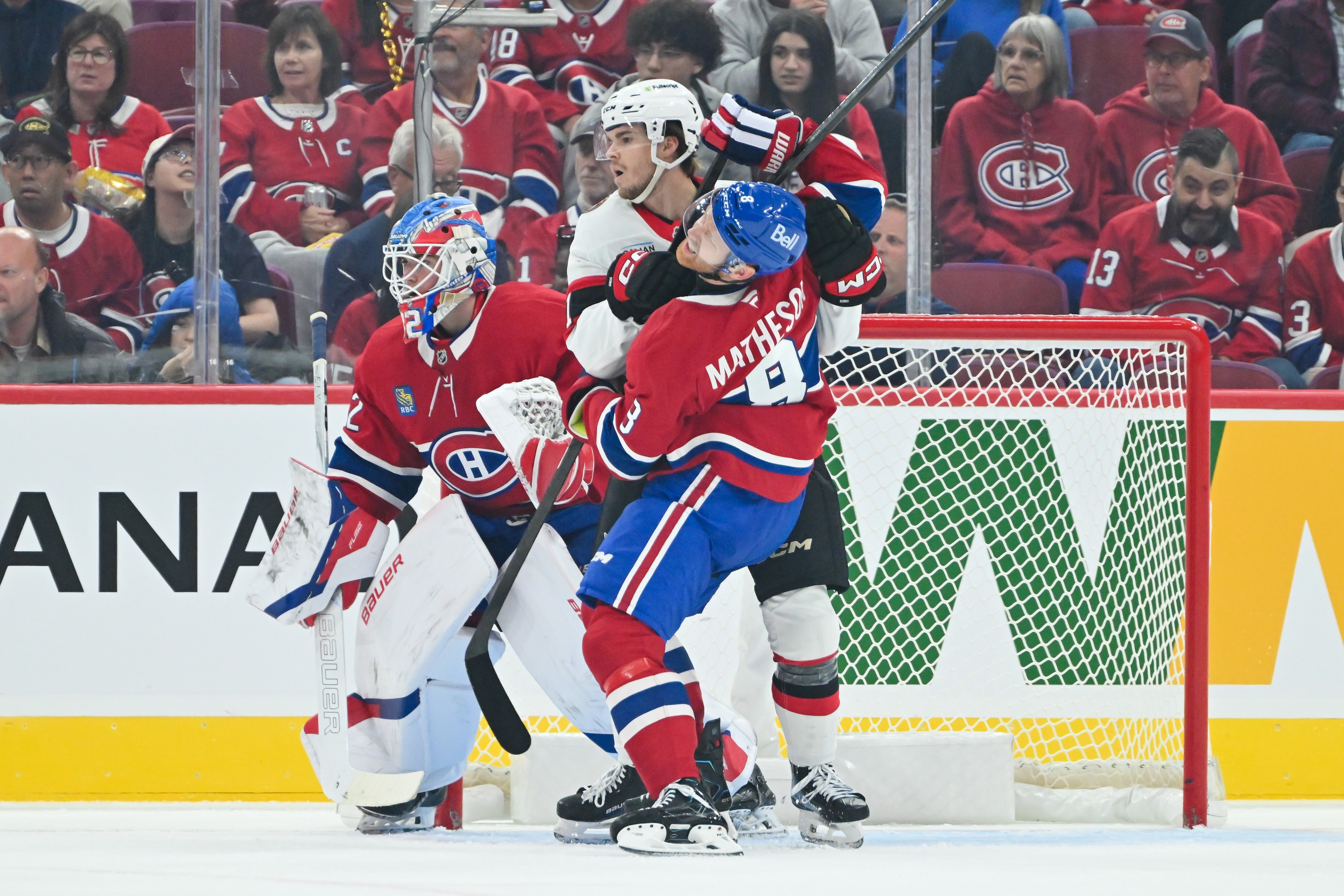 Canadiens defenceman Mike Matheson and Senators' Ridly Greig battle for position in front of goaltender Jacob Fowler during second period of pre-season game at the Bell Centre on Saturday.