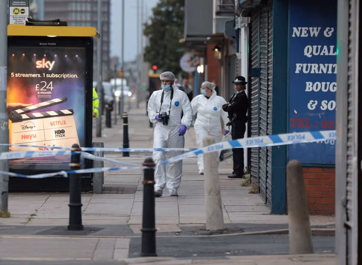 Forensic officers working inside the police cordon on Stanley Road
