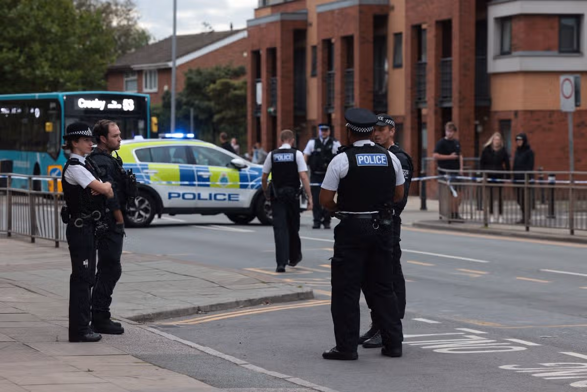 A bus sits trapped inside the Stanley Road cordon as officers work