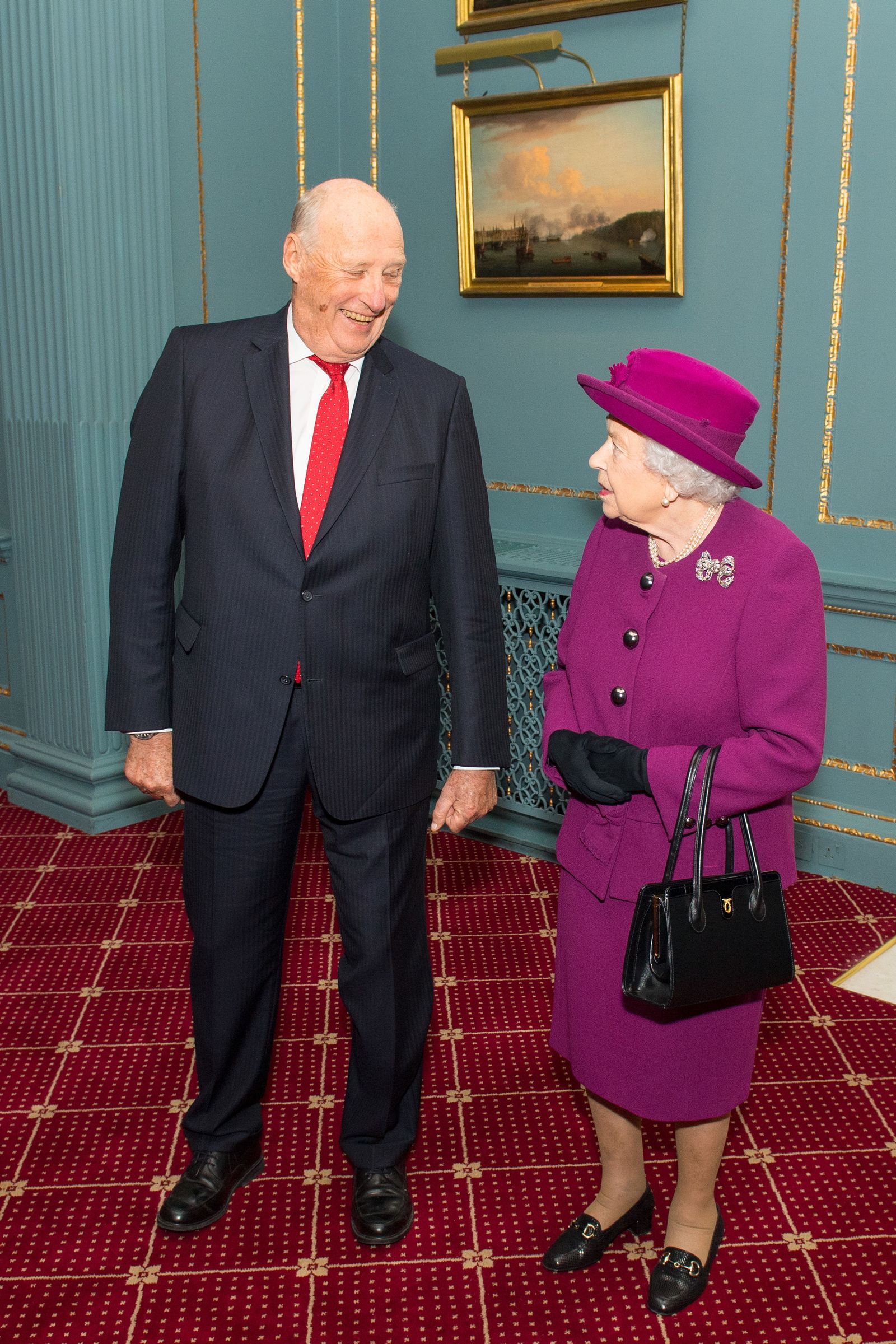 Image may contain Harald V of Norway Elizabeth II Person Adult Accessories Bag Handbag Clothing Coat Hat and Face