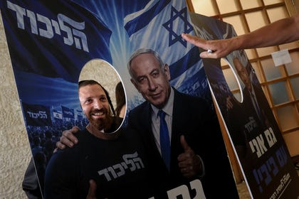 An Israeli Likud voter posing with an AI-generated photo of Israeli Prime Minister and Likud leader Benjamin Netanyahu during the party's primary in mid-August, in Jerusalem. Credit: Itay Cohen An Israeli Likud voter posing with an AI-generated photo of Israeli Prime Minister and Likud leader Benjamin Netanyahu during the party's primary in mid-August, in Jerusalem.
