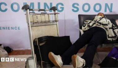 Stranded passengers rest as Soekarno Hatta International Airport closed its operations