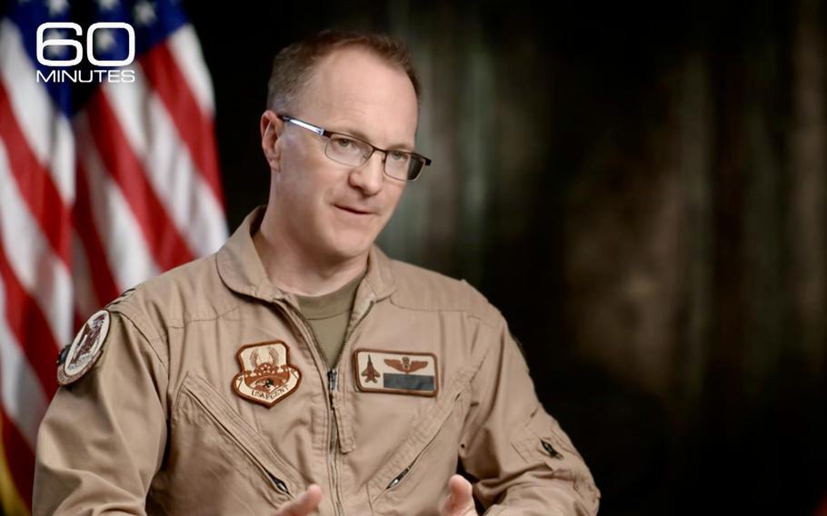 A television screenshot shows a uniformed officer being interviewed