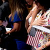 New U.S. citizens recite the Pledge of Allegiance during their naturalization ceremony in Mount Vernon, Va., in 2022.