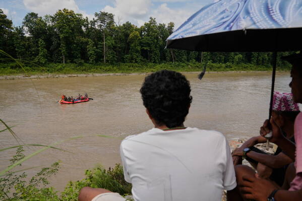 Nepalese army soldiers look for bodies of flash flood victims amid a rescue operation from a river in Chitwan, Nepal, Monday, Aug. 31, 2026. (AP Photo/Dar Yasin)