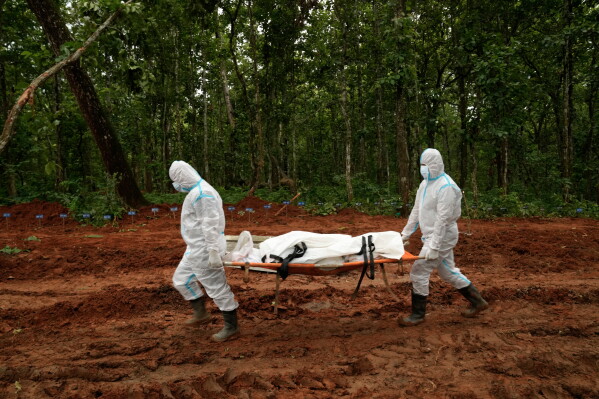 Nepal's paramilitary force personnel carry the body of a flash flood victim for burial at a mass burial site in Chitwan, Nepal, Monday, Aug. 31, 2026. (AP Photo/Dar Yasin)