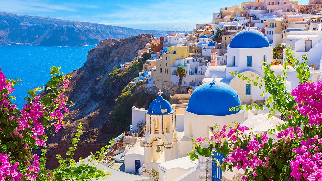 Santorini crowds driven by social media line up at Oia's blue-domed churches for photos