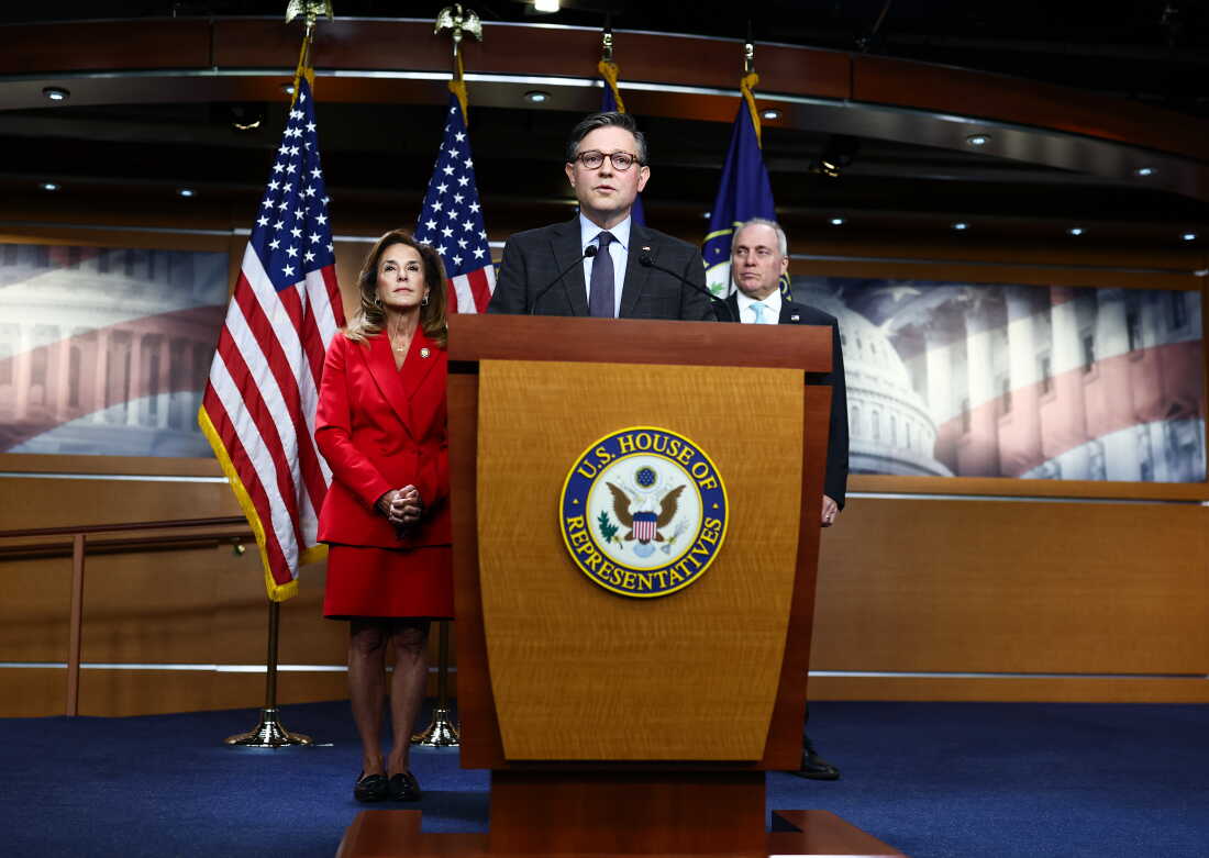 Speaker Mike Johnson, R-La., addresses reporters as Rep. Lisa McClain, R-Mich., and Majority Leader Steve Scalise, R-La., look on during a news conference Tuesday ahead of the government funding vote.