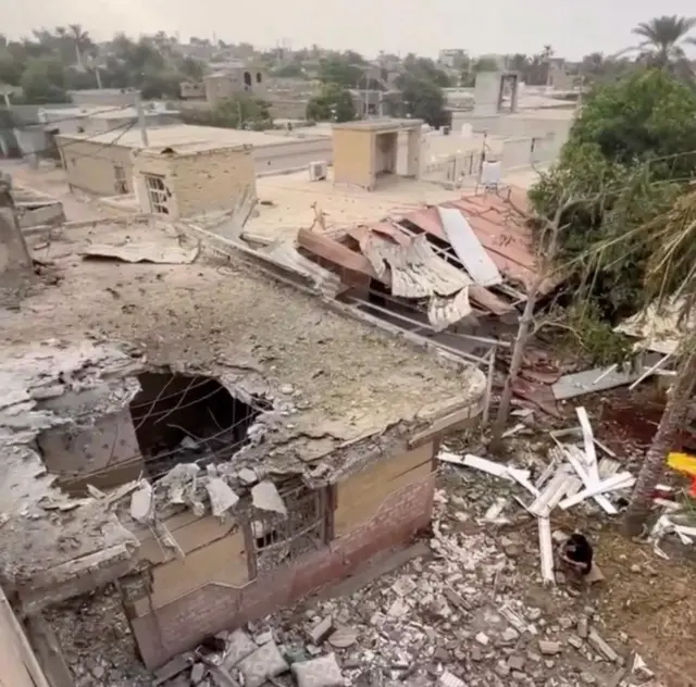 Rubble lies around damaged houses following a reported attack near a wedding gathering in Sirik, Iran