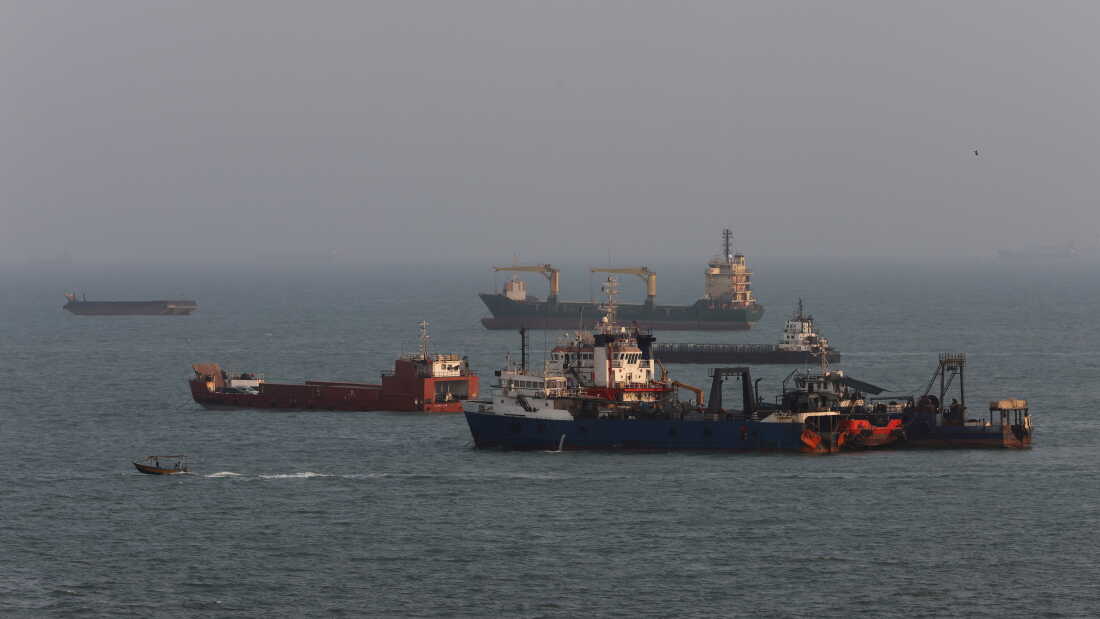Ships are anchored in the Strait of Hormuz off the coast of Bandar Abbas, Iran.