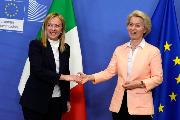European Commission President Ursula von der Leyen, right, greets Italian Prime Minister Giorgia Meloni at EU headquarters in Brussels, Thursday, Nov. 3, 2022. (AP Photo/Virginia Mayo, File)