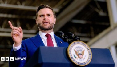 US Vice-President JD Vance speaks behind a lectern