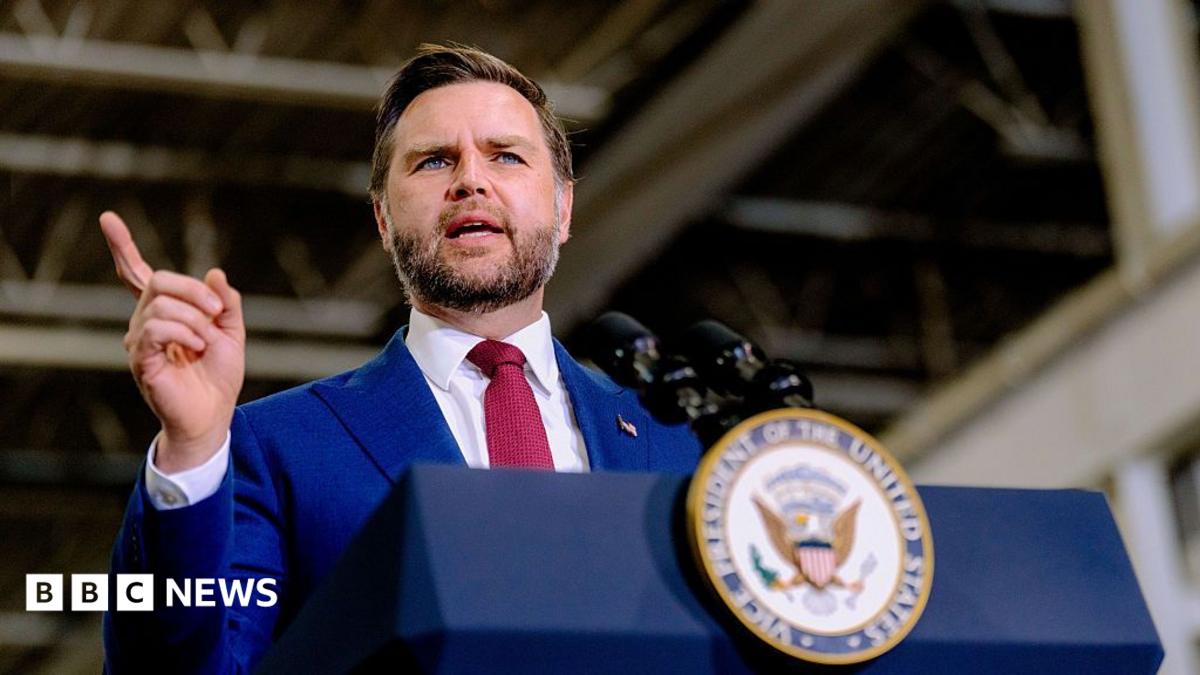 US Vice-President JD Vance speaks behind a lectern