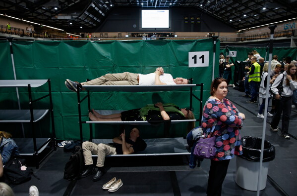 People are laying on portable beds during the civil defense exercise Shelter 2026 in Kuopio, Finland, Wednesday, Sept. 2, 2026. The exercise is testing how a large number of people can be protected in different types of disruption and during emergency conditions. (Matias Honkamaa/Lehtikuva via AP)